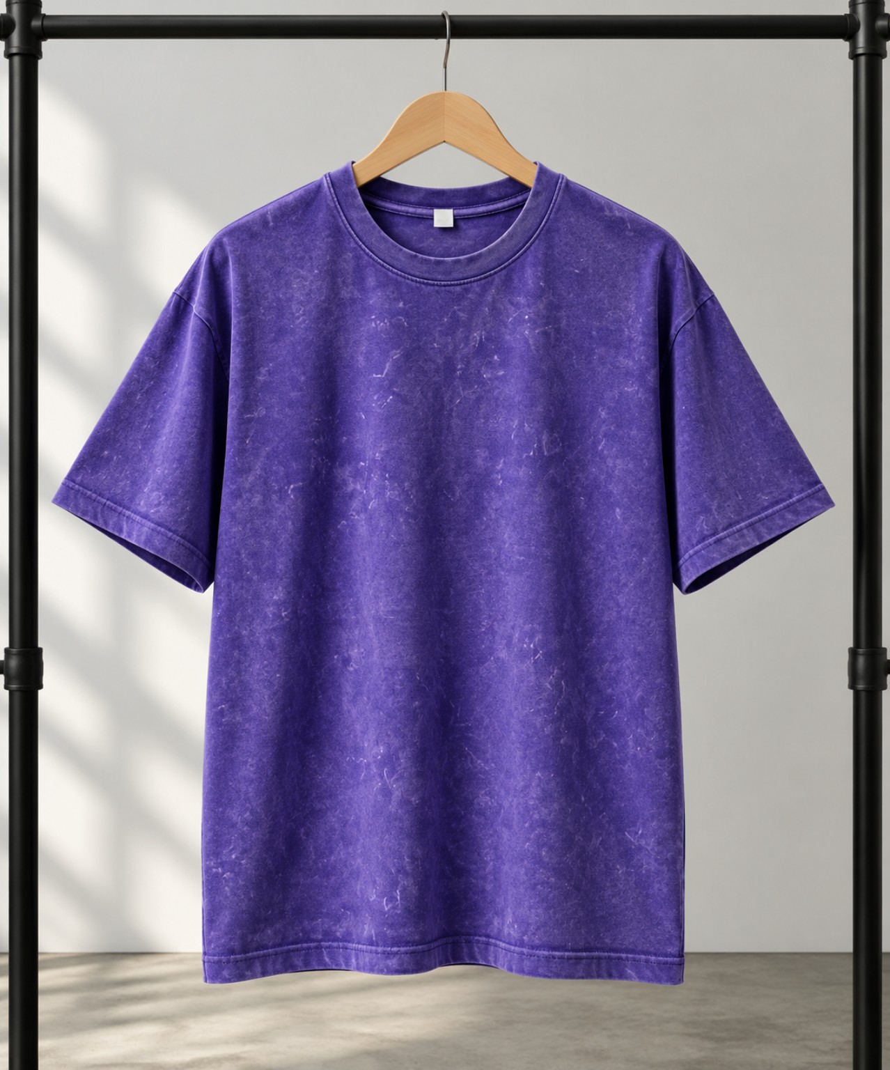 Black acid-wash oversized t-shirt on a hanger